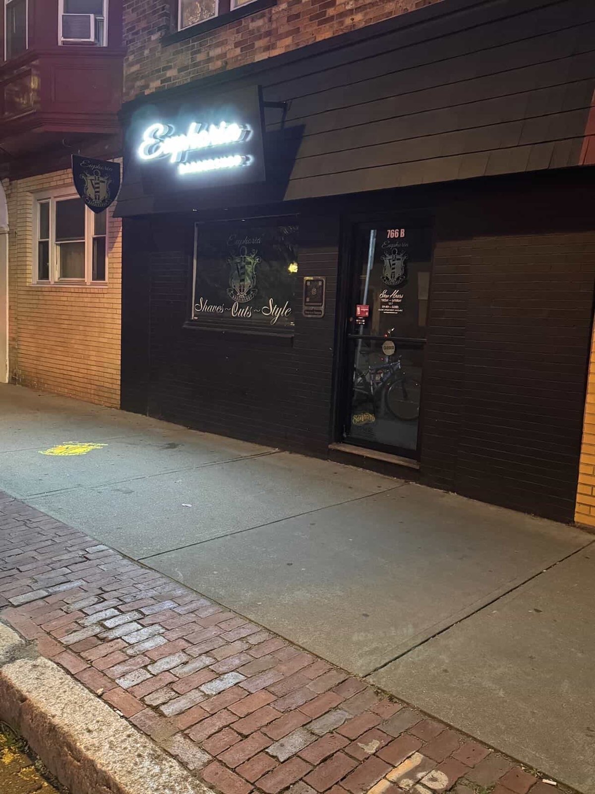 Euphoria Barbershop storefront glowing at night