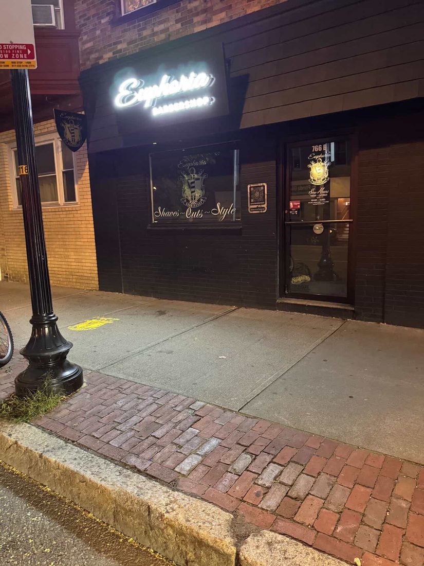 Outside Euphoria Barbershop at night